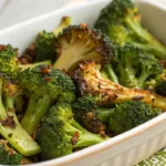 Crispy roasted broccoli on a baking sheet with golden edges.